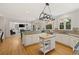 Open kitchen with white cabinets, granite counters, breakfast bar, and seamless flow to living room at 2030 Darien Park Dr, Roswell, GA 30076