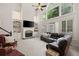 Bright living room features a stone fireplace, built-in shelving, and expansive windows at 2030 Darien Park Dr, Roswell, GA 30076