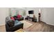 Spacious living room features hardwood floors, black couches, and large windows at 2030 Darien Park Dr, Roswell, GA 30076