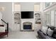 Comfortable living room with stone fireplace, built-in shelving and plush sectional couch at 2030 Darien Park Dr, Roswell, GA 30076