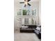 Cozy living room has large windows, and a brown leather sectional sofa at 2030 Darien Park Dr, Roswell, GA 30076