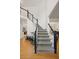 Foyer staircase with hardwood floors and views into adjacent living and kitchen areas at 2030 Darien Park Dr, Roswell, GA 30076