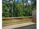 Wooden back deck overlooking a grassy backyard surrounded by trees at 261 Mahone Dr, Lilburn, GA 30047