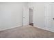Clean, carpeted bedroom with white trim and doors at 261 Mahone Dr, Lilburn, GA 30047