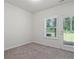 Neutral bedroom with large windows and a door to the backyard at 261 Mahone Dr, Lilburn, GA 30047