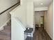 Bright entryway with wood floors, white trim, staircase, and space for a table at 261 Mahone Dr, Lilburn, GA 30047