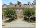 Inviting brick townhome with a two-car garage and well-manicured landscaping at 261 Mahone Dr, Lilburn, GA 30047