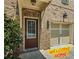 Charming front door and attached garage on a brick townhome at 261 Mahone Dr, Lilburn, GA 30047
