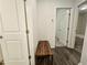 Hallway featuring wood floors, a bench, and doorways leading to other rooms at 261 Mahone Dr, Lilburn, GA 30047
