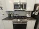 Gourmet kitchen featuring stainless steel appliances, granite counters and a subway tile backsplash at 261 Mahone Dr, Lilburn, GA 30047