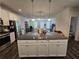 Expansive kitchen island with granite countertop and white cabinets offers ample storage and workspace at 261 Mahone Dr, Lilburn, GA 30047