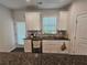 Bright kitchen features stainless steel appliances, granite counters and white cabinets at 261 Mahone Dr, Lilburn, GA 30047