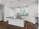 Bright kitchen with granite countertops, white cabinets, and stainless steel appliances at 261 Mahone Dr, Lilburn, GA 30047