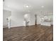Open-concept living room with hardwood floors and stairs to the next level at 261 Mahone Dr, Lilburn, GA 30047
