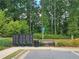 Community mailboxes near a bench surrounded by green landscape, set against a backdrop of trees at 261 Mahone Dr, Lilburn, GA 30047
