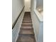 Carpeted staircase with handrail, leading to the upper level of the home at 261 Mahone Dr, Lilburn, GA 30047