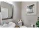 Cozy half-bathroom featuring a modern sink, toilet, and tastefully decorated wall art for a charming touch at 525 Clinton Dr, Temple, GA 30179