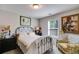 Cozy bedroom featuring neutral walls, comfortable bed, and floral accent chair at 525 Clinton Dr, Temple, GA 30179