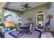 Inviting covered patio with ceiling fan, dining table, and outdoor decor at 525 Clinton Dr, Temple, GA 30179