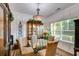 Bright dining room with stylish chandelier, glass table, and decorative china cabinet, perfect for entertaining at 525 Clinton Dr, Temple, GA 30179