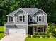 Charming two-story home with gray siding, black shutters, and a well-maintained front yard at 525 Clinton Dr, Temple, GA 30179