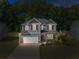 Beautiful home at dusk with manicured lawn and ambient lighting, creating a warm and welcoming atmosphere at 525 Clinton Dr, Temple, GA 30179