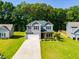Inviting two-story home with a wide driveway and lush green lawn, perfect for Gathering living at 525 Clinton Dr, Temple, GA 30179