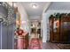 Elegant foyer featuring hardwood floors, antique furniture, and a decorative mirror, showcasing classic charm at 525 Clinton Dr, Temple, GA 30179