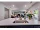 Open concept kitchen with stainless steel sink and views of the open living area, and granite countertops at 525 Clinton Dr, Temple, GA 30179
