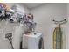 Efficient laundry room with washing machine, shelving, and ironing board at 525 Clinton Dr, Temple, GA 30179