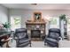 Inviting living room with a stone fireplace, comfortable armchairs, and bright windows, creating a relaxing space at 525 Clinton Dr, Temple, GA 30179