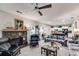 Spacious open-concept living room with a fireplace, floral sofa, and a view into the modern kitchen at 525 Clinton Dr, Temple, GA 30179