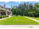 Manicured backyard with a covered porch, dining area, lush lawn, perfect for outdoor living and entertainment at 101 Morgan Ln, Canton, GA 30115