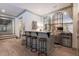 Stylish home bar with four stools, marble countertop, mirrored backsplash, and stainless steel appliances at 101 Morgan Ln, Canton, GA 30115