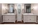 Elegant bathroom featuring dual vanities, decorative mirrors, and a central linen cabinet, offering both style and functionality at 101 Morgan Ln, Canton, GA 30115