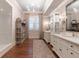 Spacious bathroom featuring double vanities, glass enclosed shower, wood floors, and custom cabinetry at 101 Morgan Ln, Canton, GA 30115