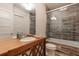 Modern bathroom with wood-look tile, glass shower door, and updated vanity at 101 Morgan Ln, Canton, GA 30115