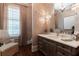 Elegant bathroom featuring designer wallpaper, a chandelier, and plantation shutters at 101 Morgan Ln, Canton, GA 30115