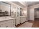 Bright bathroom features a classic design with dual vanities, decorative mirrors, and a linen cabinet for ample storage at 101 Morgan Ln, Canton, GA 30115