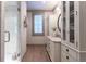 Elegant bathroom featuring a glass-enclosed shower, white vanity, marble countertop, and wood-look flooring at 101 Morgan Ln, Canton, GA 30115