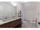 Well-lit bathroom featuring stylish tile floors, double vanity, and modern fixtures at 101 Morgan Ln, Canton, GA 30115