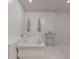 Relaxing bathroom with a standalone tub, tiled floors, and a sleek towel rack for a modern and clean aesthetic at 101 Morgan Ln, Canton, GA 30115