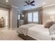 Comfortable bedroom featuring a ceiling fan, dresser with mirror, and plush carpeting at 101 Morgan Ln, Canton, GA 30115