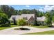 Beautiful home featuring a well-manicured lawn, mature trees, landscaping, and a brick and siding exterior at 101 Morgan Ln, Canton, GA 30115