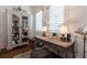 Cozy home office with a vintage desk, an upholstered chair, a display cabinet, and window shutters at 101 Morgan Ln, Canton, GA 30115