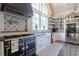 Charming kitchen features a black stove, farmhouse sink, granite countertops, and decorative tile backsplash at 101 Morgan Ln, Canton, GA 30115