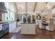 Open kitchen boasts a large island, white cabinets, black countertops, and modern appliances at 101 Morgan Ln, Canton, GA 30115