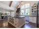 Modern kitchen features a large island with drawers, stainless steel appliances, and high ceilings with beams at 101 Morgan Ln, Canton, GA 30115