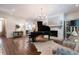 Bright living room featuring a fireplace, grand piano, hardwood floors, and stylish decor at 101 Morgan Ln, Canton, GA 30115