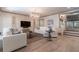 Inviting living room with white sofas, decorative artwork, and sleek hardwood floors at 101 Morgan Ln, Canton, GA 30115